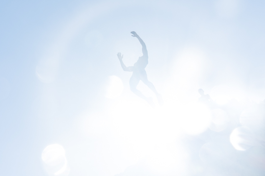 man-jumping-sky-blue-sun-halo